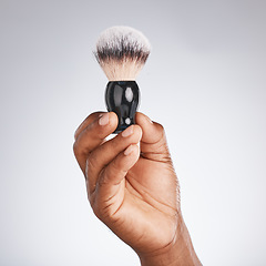 Image showing Hand, brush and shaving with beauty and black man, hygiene and grooming with skincare mockup. Shave, body hair care and cosmetic tools marketing with barber equipment against studio background