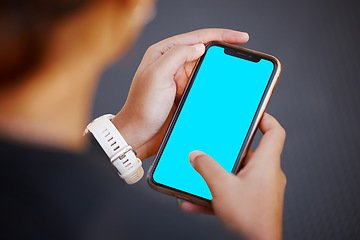 Image showing Hands, phone and green screen with mockup for advertising or marketing on display screen from above. Logo, brand or social media with a mobile smartphone in the hand for blue screen product placement