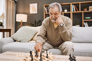 Image showing Senior man, thinking or playing chess in house, home living room or apartment in Japanese strategy, checkmate or board game contest. Retirement elderly, smart person or chessboard challenge for mind