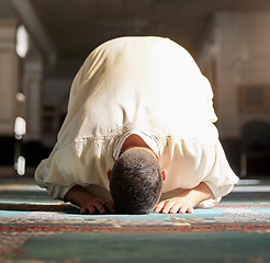 Image showing Islam, religion and prayer of a muslim man at mosque in ramadan for spiritual faith, God and belief while doing religious worship. Islamic or Arab culture people sitting to pray at holy place