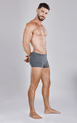 Image showing Portrait, body and a man underwear model in studio on a gray background to promote a brand of drawers. Health, fitness and wellness with a handsome young male posing in underpants for comfort