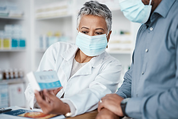 Image showing Covid, pharmacy and woman with box consulting patient on prescription, medication or medicine. Corona, healthcare and senior female medical professional showing black man health product in drug store