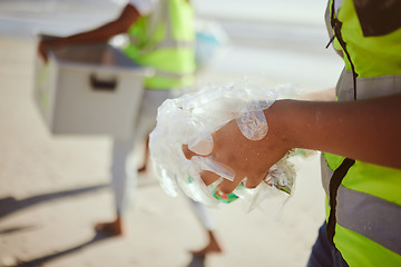 Image showing Cleaning, plastic and hands of volunteer at beach for recycle, environment or earth day. Recycling, sustainability and climate change with charity team and trash for pollution, eco friendly and help