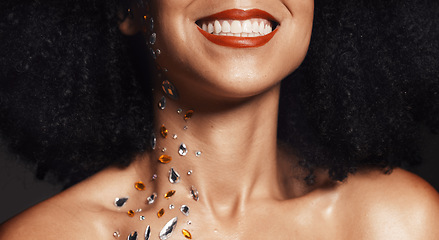 Image showing Woman face, fashion jewelry or body art rhinestones on black background studio in festival diamonds sparkle or creative party crystals. Zoom, happy smile or beauty model skin and makeup cosmetic gems