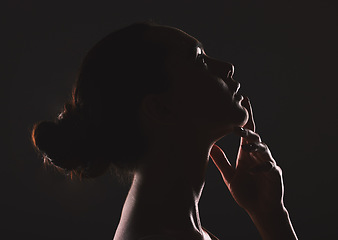 Image showing Woman beauty silhouette, face and dark, sexy with cosmetics and seductive fantasy with mysterious aesthetic. Female profile with skin, sexy woman facial and shadow against black studio background.