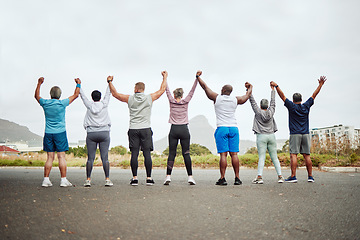 Image showing Holding hands, fitness group of people winning, yes or celebration exercise, workout and training goals in city rear. Wellness, community and senior friends teamwork, accountability and success sign