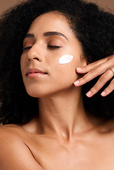 Image showing Cosmetics, black woman and cream for organic facial collagen and brown studio background. Jamaican female, girl and face lotion for healthy, smooth or soft skin for spa treatment, self care or luxury