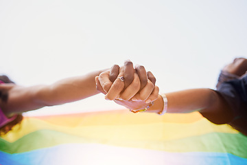 Image showing LGBTQ flag, rainbow and couple holding hands for gay pride, lesbian support or human rights protest. LGBT community, sky and African black people together in love, partnership and equality below view