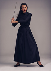 Image showing Samurai, sword and portrait of a ninja in a studio with a martial arts or assassin fighter skill. Fantasy, cosplay and female model in a warrior costume with a machete posing by a gray background.