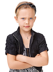 Image showing Portrait, angry and children with an unhappy girl standing arms crossed in studio isolated on a white background. Kids, attitude and frown with a female child looking moody, annoyed or frustarted