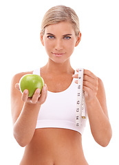 Image showing Woman, apple and measure tape in studio portrait for wellness, nutrition or happiness by white background. Isolated model, fruit and goal to lose weight for vitamin c, natural diet or healthy food