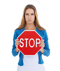 Image showing Woman, studio portrait and holding stop sign in hands for serious, assertive or angry face by white background. Activist model, stop and anger for equality, transparency or isolated for woman rights