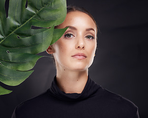 Image showing Woman, skincare and studio portrait with leaf, beauty and natural glow for cosmetics, self care or fashion. Model, cosmetic beauty and monstera leaves with dark aesthetic, face and black background