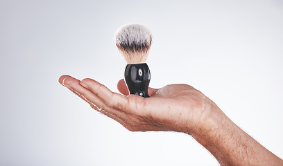 Image showing Makeup, cosmetics and hand of man with brush in studio isolated on a gray background mockup. Skincare, aesthetics and male model holding product, accessory or tool for grooming, beauty and wellness.