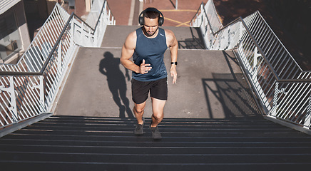 Image showing Urban fitness, man running on stairs and listening to music on headphones on outdoor exercise in Los Angeles. Health, motivation and a California city runner on steps for marathon training in morning