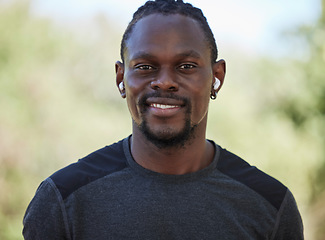 Image showing Fitness, black man and portrait of happy runner, earphones and training exercise in Nigeria park. Face, smile and sports athlete listening to music for motivation, healthy goals and wellness workout