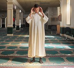 Image showing Muslim, prayer or man in a mosque praying to Allah for spiritual mindfulness, support or wellness in Doha, Qatar. Religion, peace or Islamic person in temple to worship or praise God with gratitude