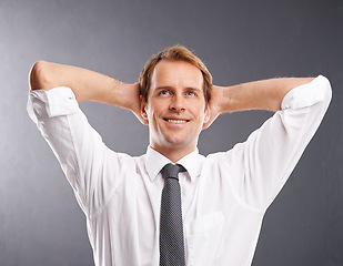 Image showing Business man, happy and thinking to relax with a smile and idea for future, vision and career in studio. Face of a male entrepreneur with hands behind head to think about decision, ideas or choice