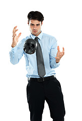 Image showing Business man, levitation and black skull in studio isolated on a white background. Magician, spirit and male employee levitating head or scalp in air for evil, death or occult, voodoo or magic trick.