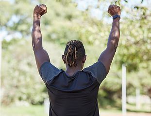 Image showing Winner, fitness and black man running outdoor with success, exercise in park with training and active lifestyle. Runner back view, freedom with workout and sports motivation, celebration, win and run