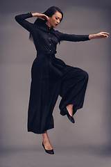 Image showing Fitness, martial arts and woman jump in studio isolated on a gray background. Tai chi sports, karate meditation or young female fighter jumping in air getting ready for workout, exercise or training