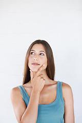 Image showing Hand, woman and thinking in studio with an idea, vision and decision on white background space. Ideas, choice and girl planning, pensive and thoughtful while standing, contemplate and isolated