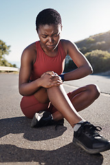 Image showing Black woman, knee and sports injury on asphalt in pain from accident, exercise or run in the outdoors. African American woman suffering leg ache holding painful area, joint or bruise during workout