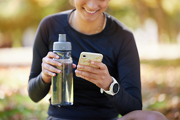 Image showing Water bottle, smartphone and woman in park for fitness website app, blog or social media exercise, workout or training update. Healthy, nutrition and cellphone technology or gear of runner in nature