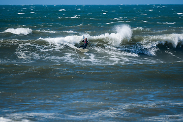 Image showing Kitesurfer riding ocean waves