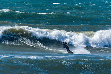 Image showing Kitesurfer riding ocean waves