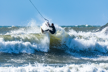 Image showing Kitesurfer riding ocean waves