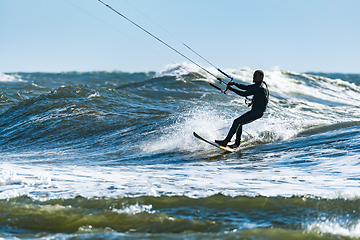 Image showing Kitesurfer riding ocean waves