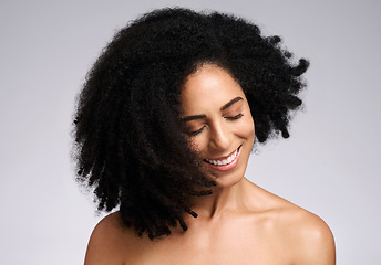 Image showing Happy, natural and hair care shake of black woman satisfied with cosmetic treatment texture and volume. Self love, smile and happiness of african hair and skincare girl in gray studio background.