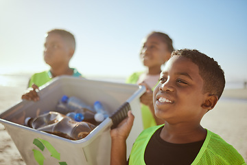 Image showing Recycle, boy and cleaning beach for sustainability, environment and awareness. Male child, volunteer and kids seaside for cleanup, plastic collection and eco friendly for pollution and global warming