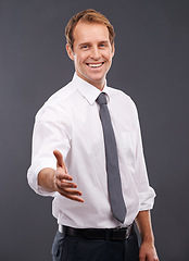 Image showing Handshake, happy and portrait of a businessman in a studio for a partnership, greeting or deal. Corporate, smile and male model with a shaking hand gesture for agreement isolated by a gray background