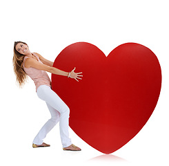 Image showing Love, studio and woman pull heart isolated on a white background. Beauty, fashion and young female model pulling heavy symbol or sign for romance emoji, affection or romantic passion, care or empathy