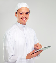 Image showing Islamic man, tablet and happy portrait for Muslim reading, education or culture standing in white background. Young person, smile and digital tech learning for religious mindset isolated in studio