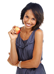 Image showing Portrait, food or black woman eating an apple in studio on white background with marketing mockup space. Smile, organic or happy African girl advertising healthy fruit diet for self care or wellness