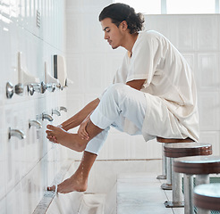 Image showing Muslim, water and man cleaning feet for ablution, wudu or spiritual purification hygiene for Islamic religion, worship or moslem culture. Indonesia mosque, Islam faith and profile of man washing foot