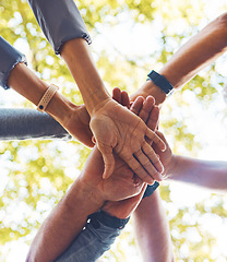 Image showing Hands, together and support with solidarity outdoor and group, diversity and team building in nature. Trust, respect and mission with community and hand stack low angle, collaboration and motivation.