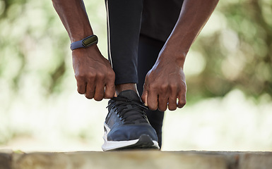 Image showing Black man with sneakers, runner and exercise outdoor with fitness run and healthy lifestyle, wellness with athlete and sport. Runner, workout shoes and body training with sports motivation and cardio