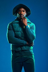 Image showing Fashion, style and portrait of black man on blue background with cool, trendy and stylish outfit. Creative, lifestyle clothing and male model pose in studio with designer, modern and edgy clothes