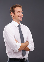 Image showing Thinking, vision and mindset with a business man in studio on a gray background for advertising or marketing. Idea, growth or future mission with a handsome male employee standing arms crossed indoor