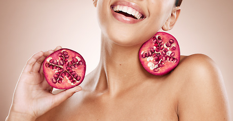 Image showing Beauty, pomegranate and skincare with woman, natural product for healthy skin, wellness and cosmetic care. Happy glow, shine with vegan cosmetics and fruit for facial treatment with studio background