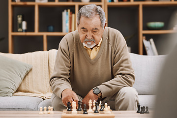 Image showing Senior man, thinking or playing chess in house, home living room or apartment in Japanese strategy, checkmate or board game contest. Retirement elderly, smart person or chessboard challenge for mind