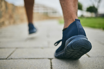 Image showing Running shoes, exercise and fitness with feet of a man outdoor on a pavement for a cardio workout. Athlete runner with sneakers for sports training for health, wellness and a healthy lifestyle