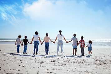 Image showing Support, back and big family holding hands at the beach, summer walking and travel holiday in nature of Portugal. Hope, love and women with affection for adopted kids on a vacation at the ocean