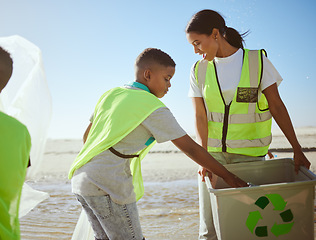 Image showing Recycling, ocean and woman with children or group at cleaning for volunteering on earth day support, help and community. Family and mother with recycle box for pollution, climate change and ecology