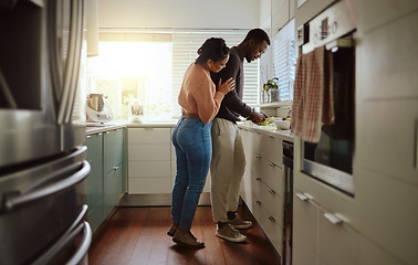 Image showing Black couple, cooking and food in kitchen at home while together to cook healthy food for dinner or lunch. Happy woman helping her man at their house or apartment to prepare a meal with love and care