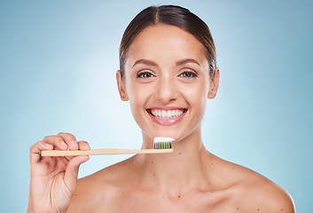 Image showing Brushing teeth, dental and woman with toothbrush for teeth whitening and beauty, oral health and fresh breath with studio background. Mouth wellness, Invisalign portrait and clean with bamboo brush.